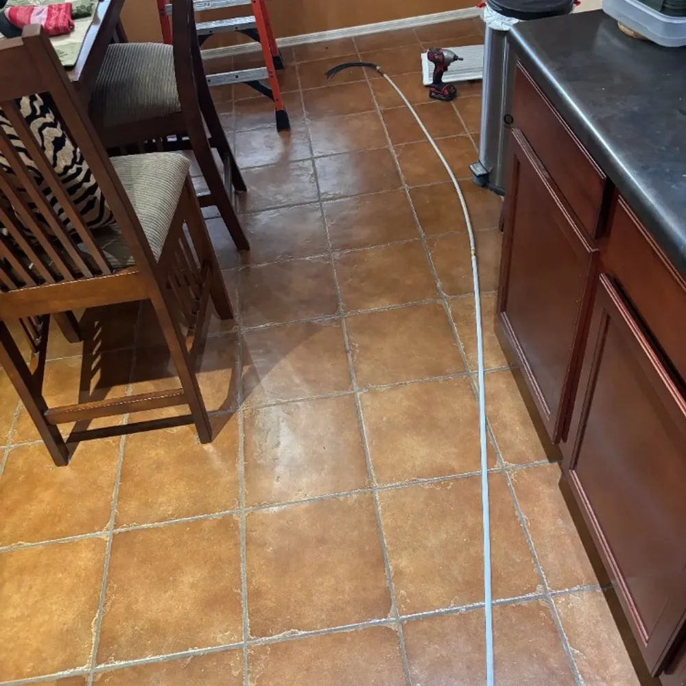 Flexible air rod system with whip head laid out on a tile floor ready for use